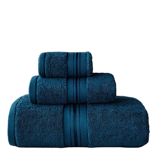 Set of three blue towels stacked on a gray surface with a dark gray background