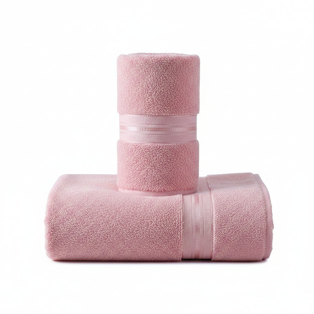Pink towel hanging on a rack against a gray wall with decorative elements.