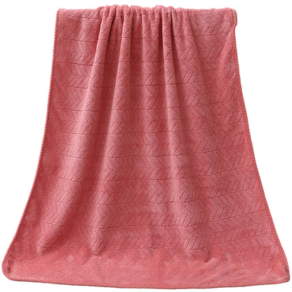 Red textured towel draped over a white bathtub