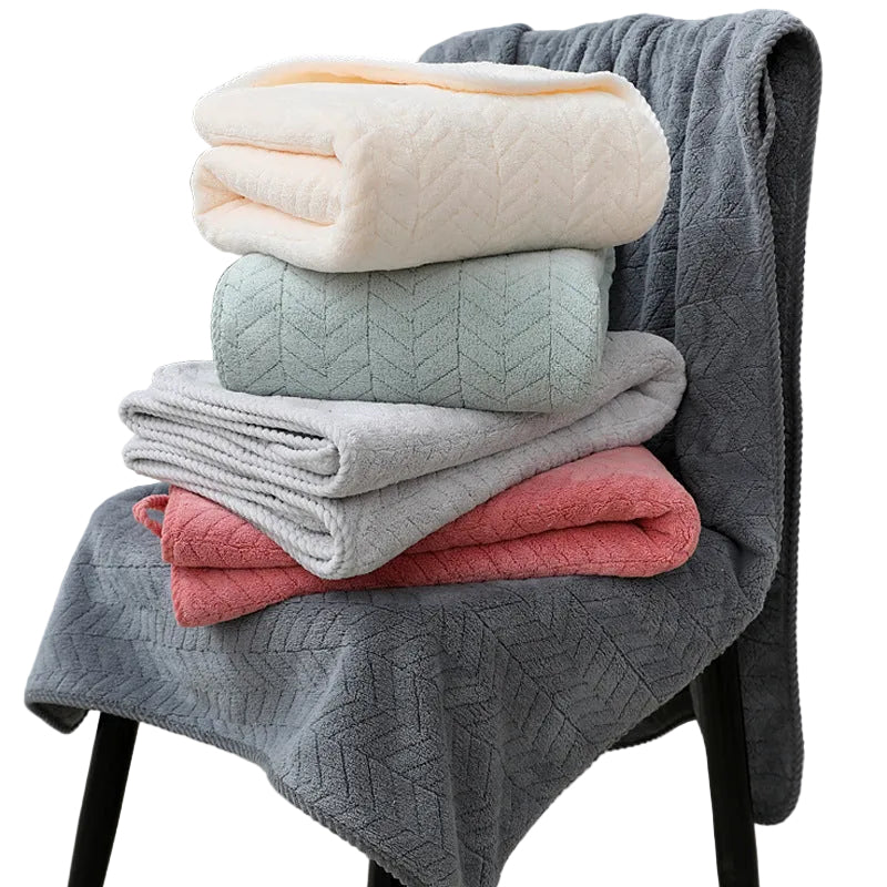 Stack of folded blankets in various colors on a chair
