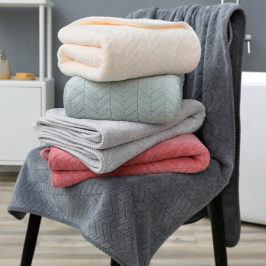 Stack of folded blankets in various colors on a chair
