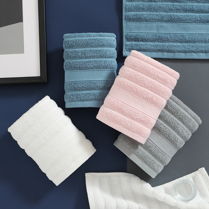 Set of folded towels in various colors on a dark surface