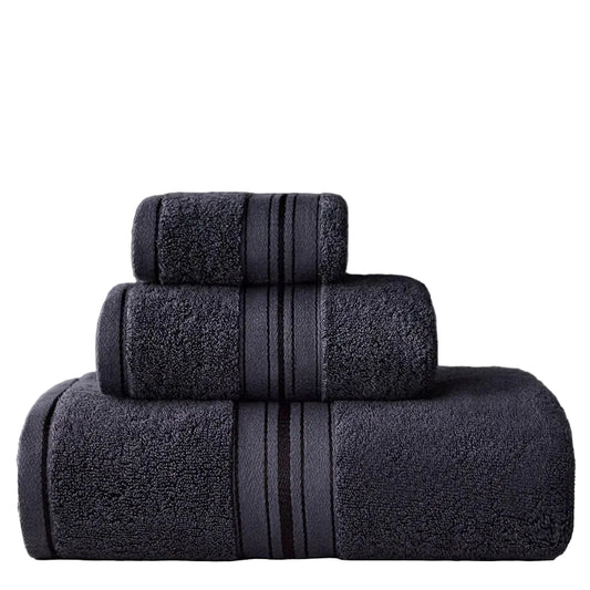 Set of dark gray towels with striped patterns on a gray background