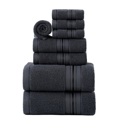 Stack of dark gray towels on a light gray background