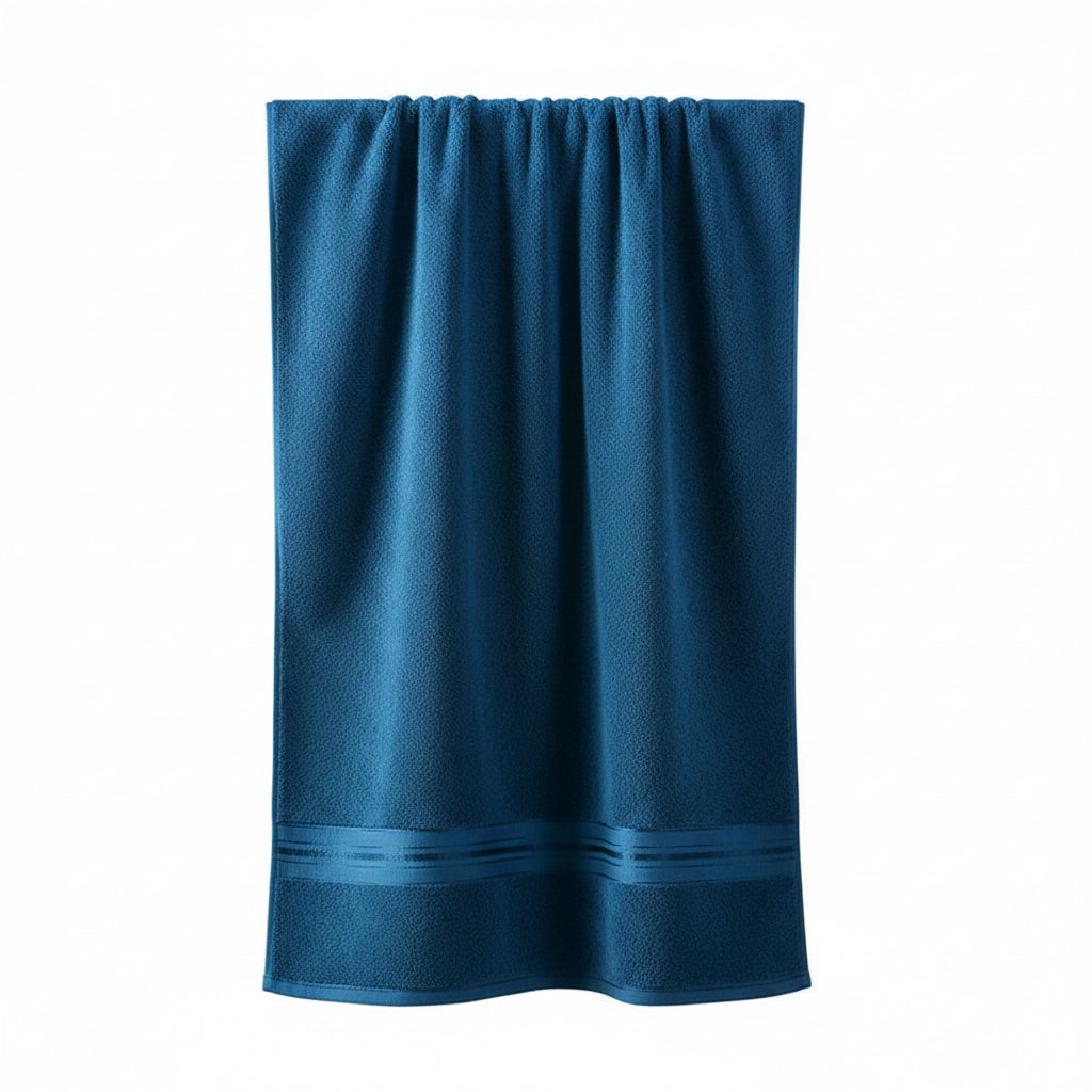Blue towel hanging on a rack against a gray wall with decorative items.
