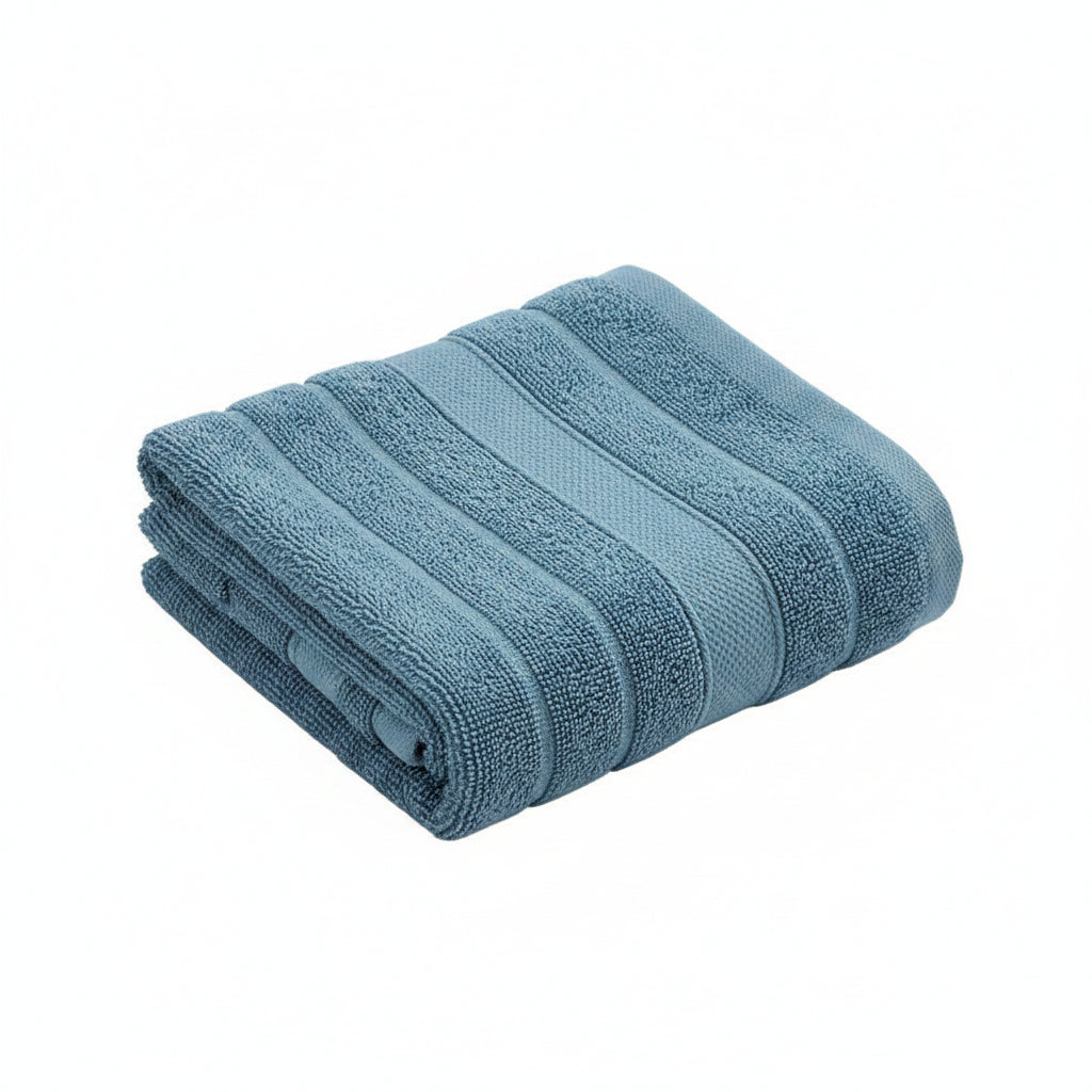 Stack of blue towels on a dark surface