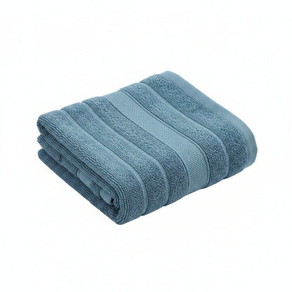 Stack of blue towels on a dark surface