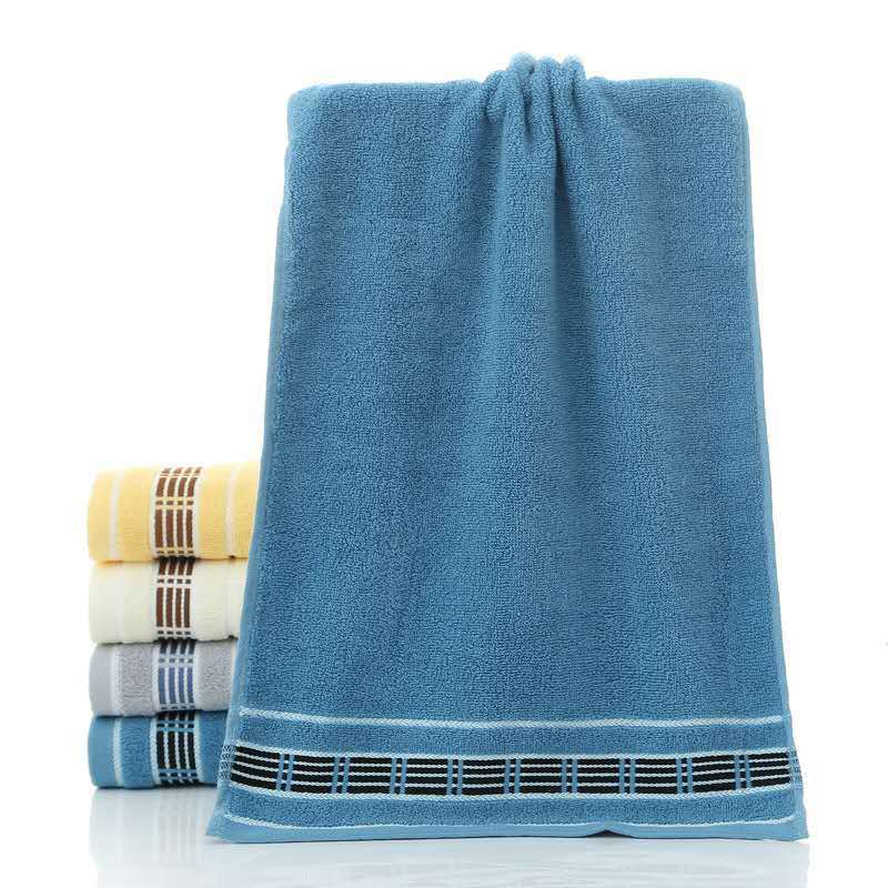 Blue towel with decorative hem on a white background