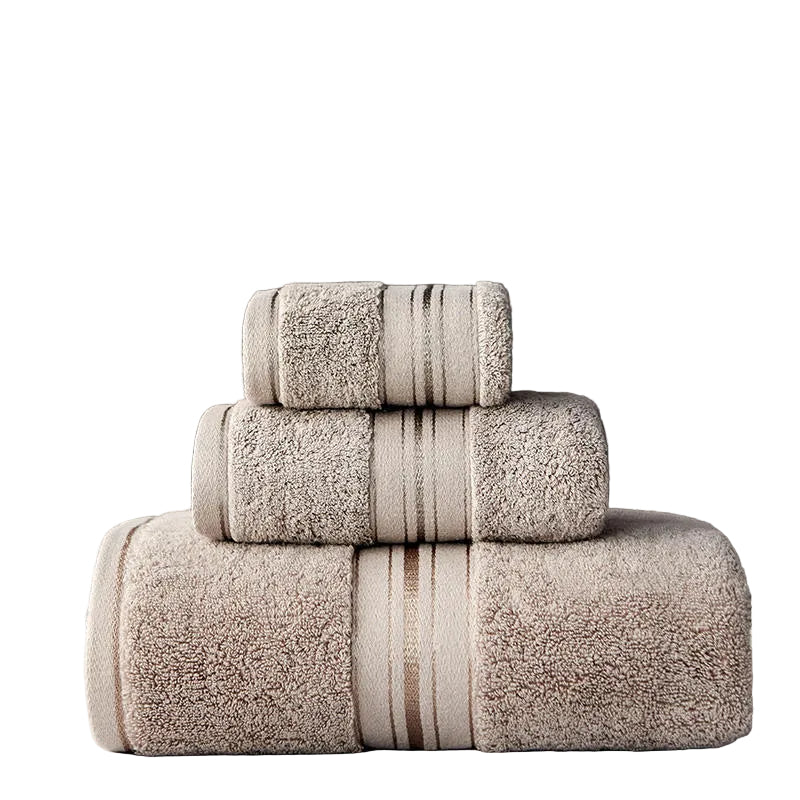 Stack of beige towels with striped patterns on a dark background