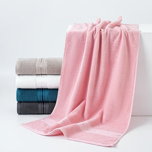 Stack of folded towels including pink, gray, white, and blue on a white background
