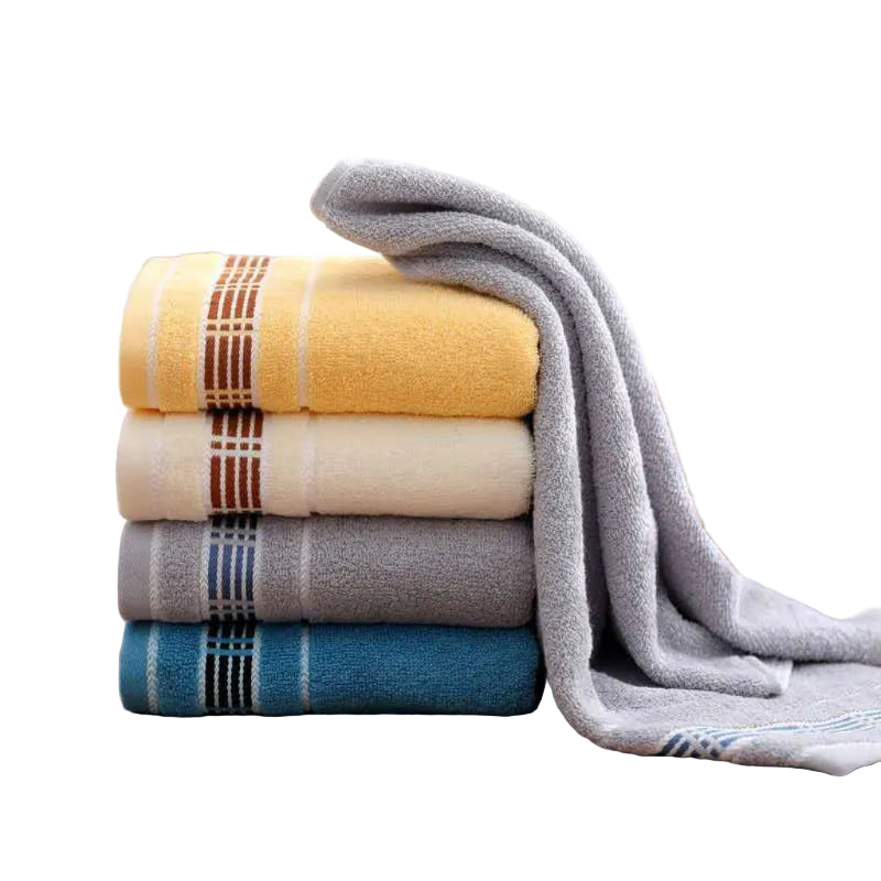 Stack of colorful towels on a wooden surface with a neutral background