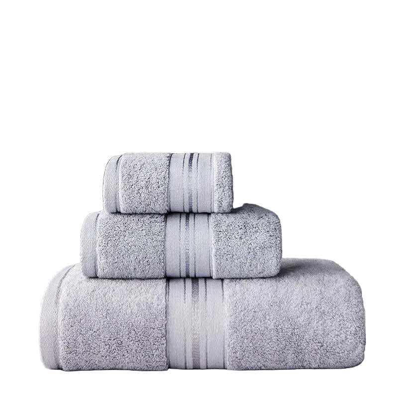 Stack of gray towels on a wooden surface with a dark background