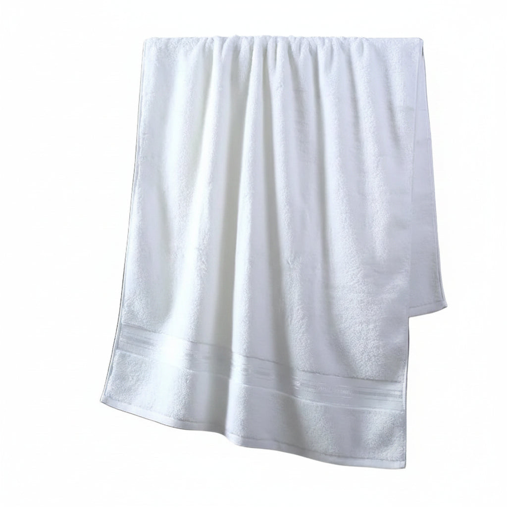 White towel hanging on a rack against a gray wall with decorative elements.