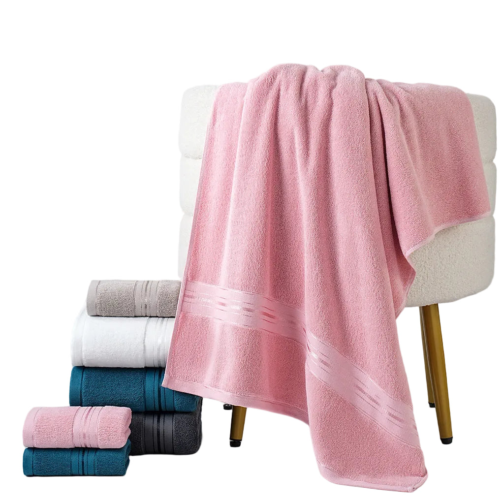 Stack of colorful towels with a pink towel draped over a chair on a light gray background
